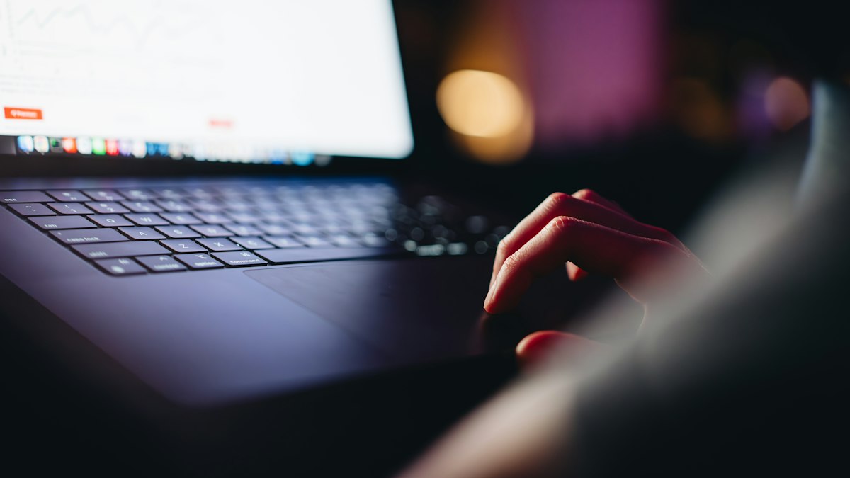 A person sitting in front of a laptop computer